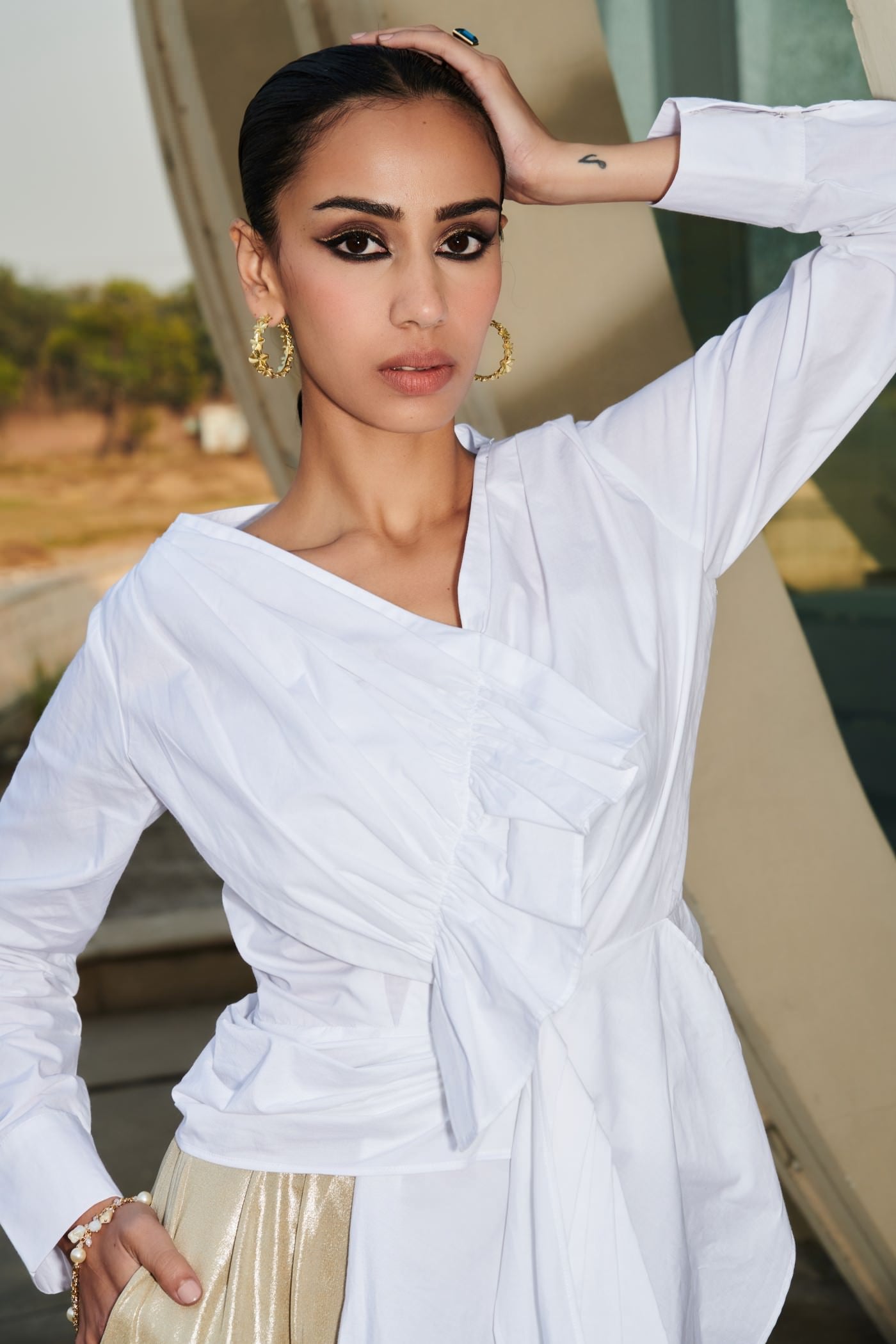 White Asymmetrical Draped Top With Golden Pants